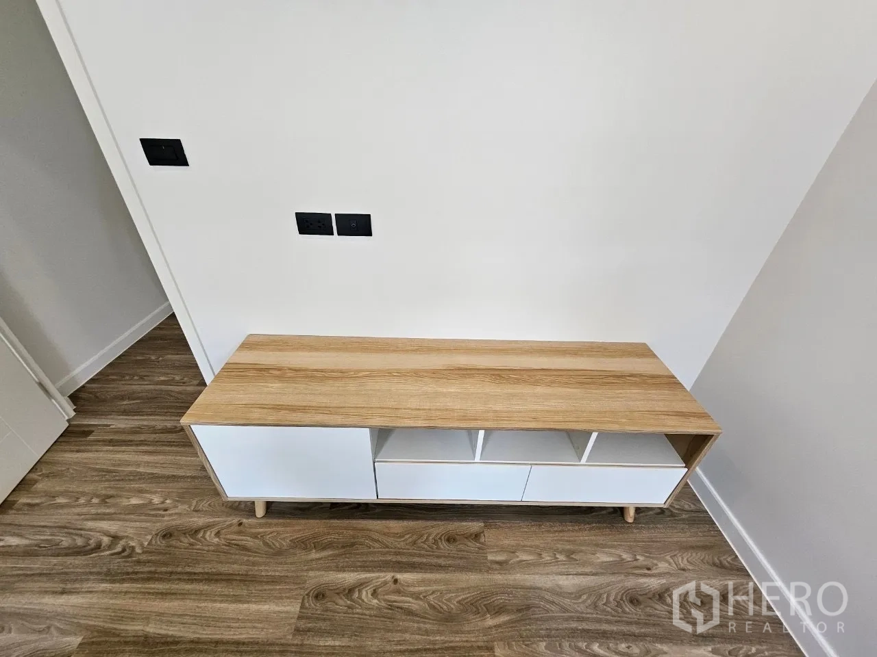 Detached House for rent in Bang Kapi, Bangkok - Low wood and white storage cabinet set on timber flooring.