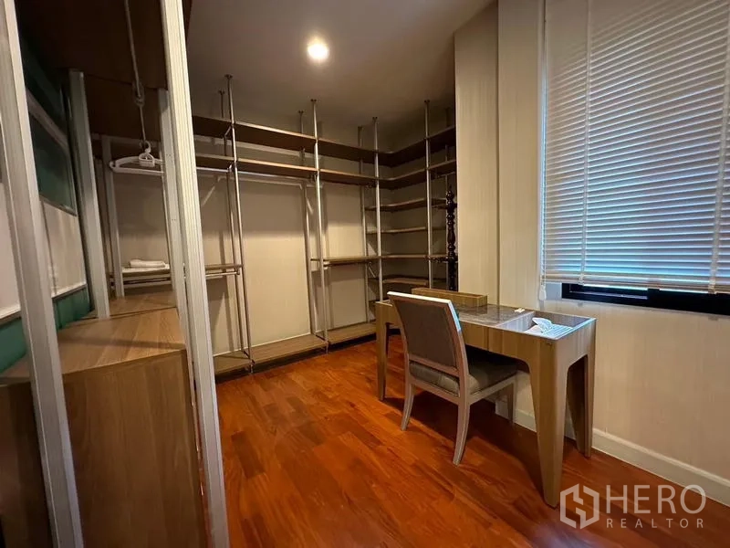 Detached House for rent or sale in Khan Na Yao, Bangkok - Walk-in closet with open shelving, hanging rails and a small desk.