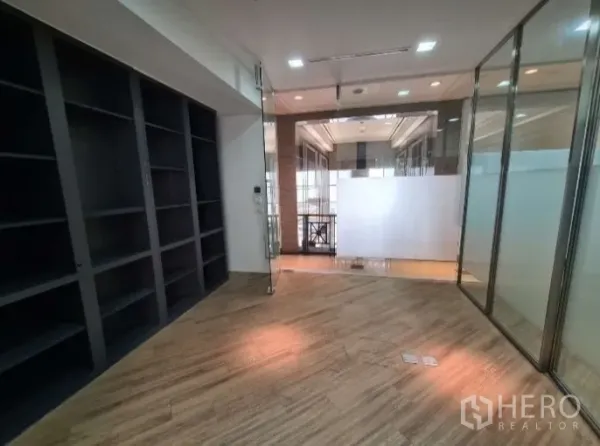 Office Space for rent - Private room with glass partitions, wood floors, and built-in shelves.