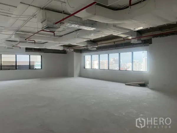 Office Space for rent - Corner office area featuring a long row of windows filling the unfurnished space with natural light.