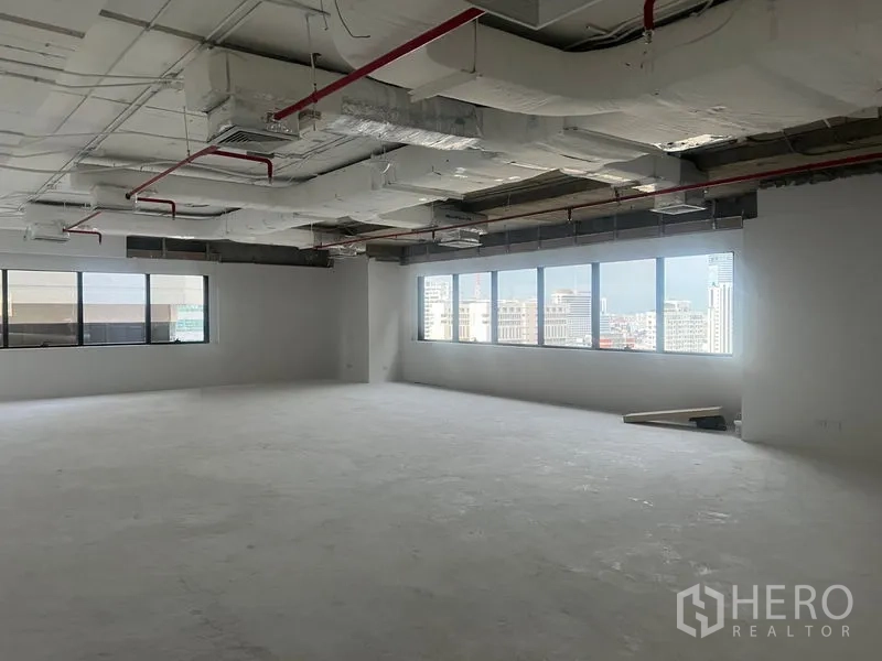Office Space for rent - Corner office area featuring a long row of windows filling the unfurnished space with natural light.