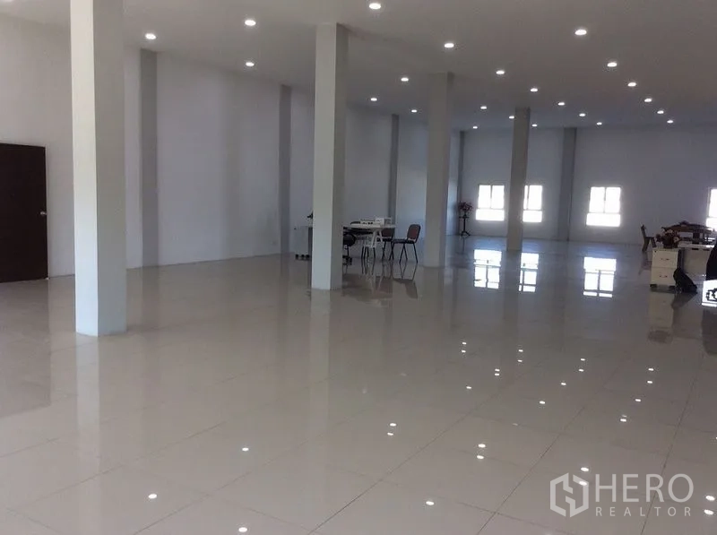Factory for sale in Bang Sao Thong, Samut Prakan - Large open office hall with multiple columns, workstations and recessed lighting.