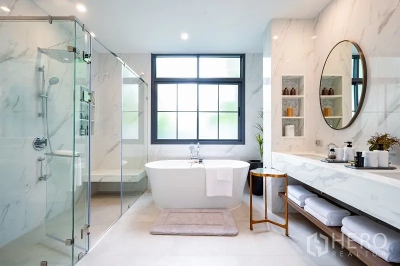 Detached House for sale in Bang Kapi, Bangkok - Luxury bathroom featuring a freestanding tub, glass shower, marble finishes and a large window.