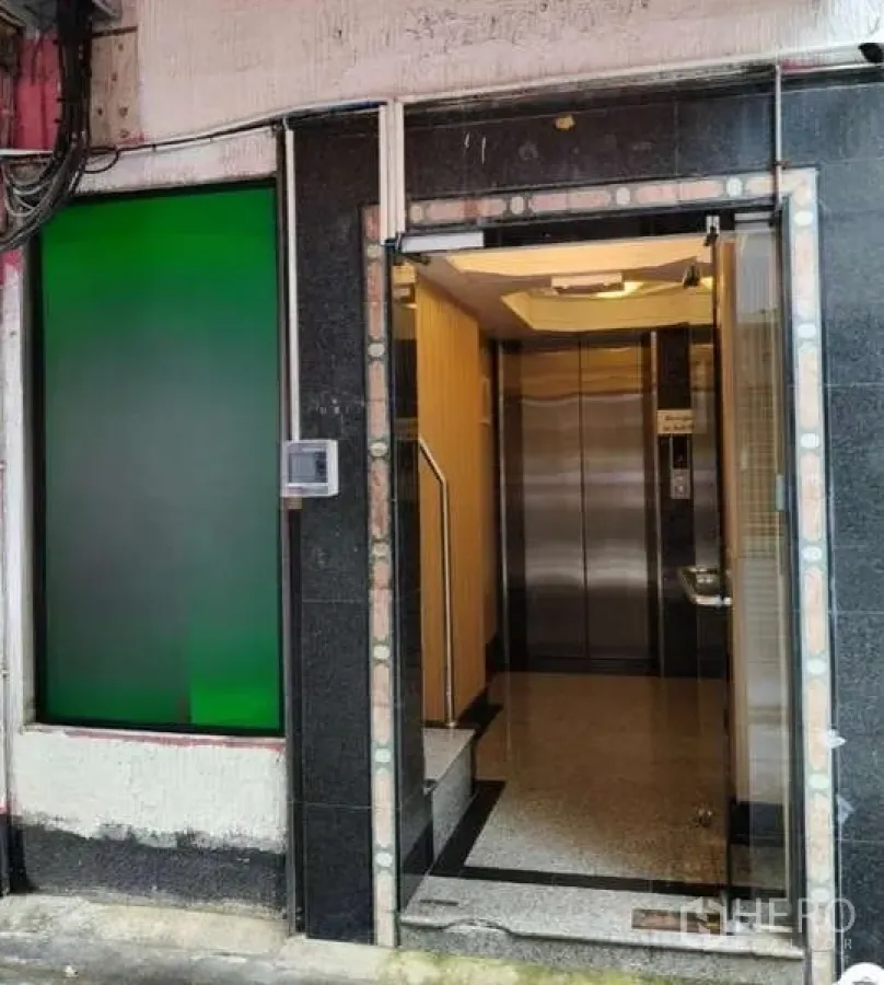 Retail Space for rent in Khlong Toei, Bangkok - Building entrance with glass door and stainless-steel elevator visible inside.