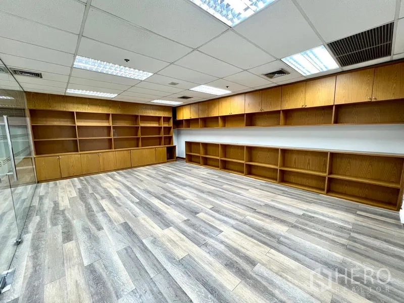 Office Space for rent in Watthana, Bangkok - Document room with long rows of wooden shelves and lower cabinets.