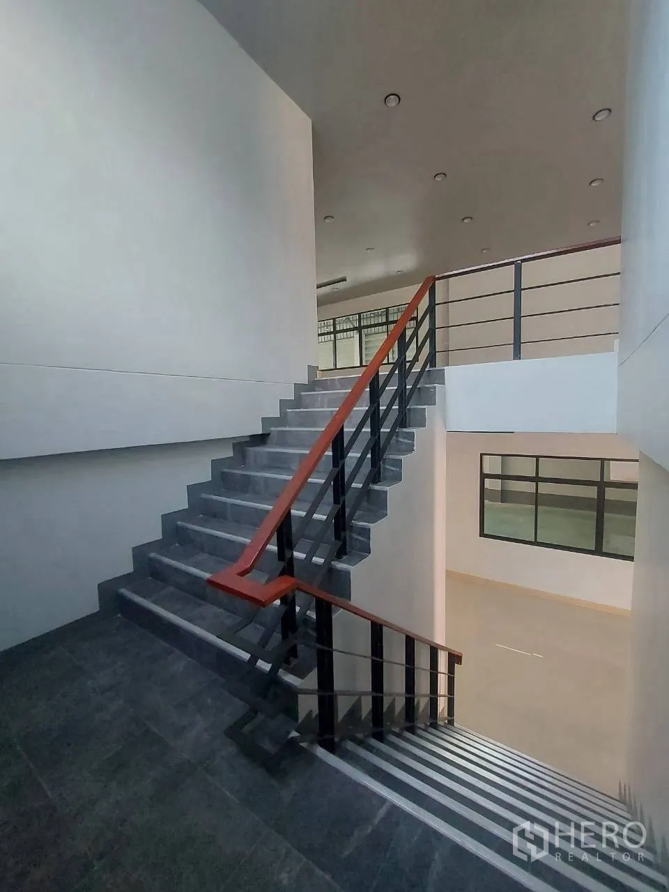 Factory for rent in Krathum Baen, Samut Sakhon - Internal staircase with metal handrails leading to the upper office level.