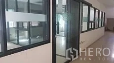 Factory for sale in Lam Luk Ka, Pathum Thani - Glass-partitioned office corridor overlooking the workshop area.