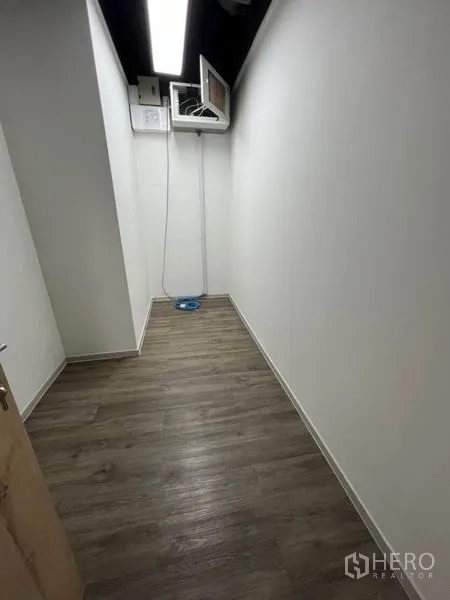 Office Space for rent in Khlong Toei, Bangkok - Narrow storage or server room with utility panel and strip lighting.