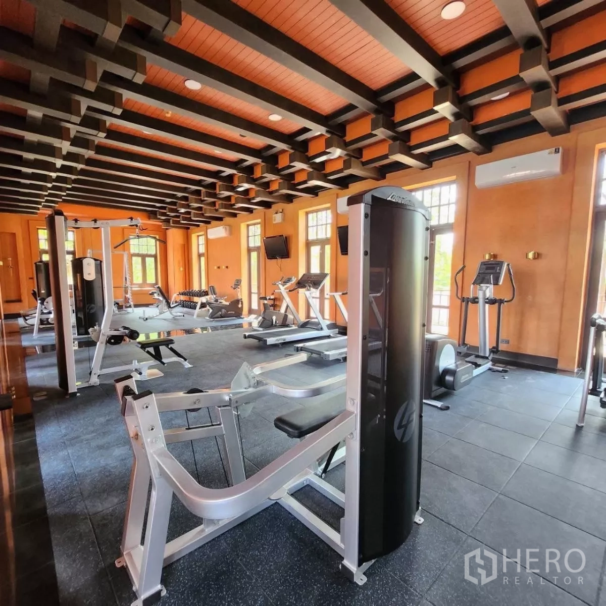 Detached House for rent or sale in Mueang Nonthaburi, Nonthaburi - Residents’ fitness center with weight and cardio machines under a beamed ceiling.