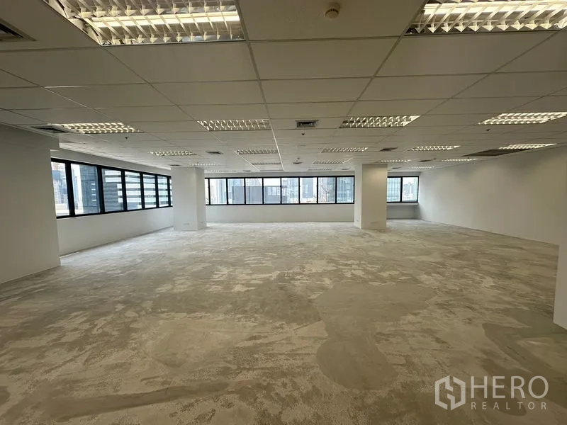 Office Space for rent in Bang Rak, Bangkok - Corner office area with long bands of windows providing abundant natural light.