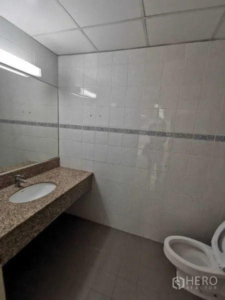 Office Space for rent in Watthana, Bangkok - Tiled restroom with granite countertop sink and toilet inside the office floor.