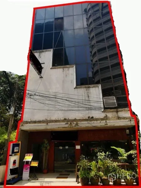 Retail Space for rent or sale in Watthana, Bangkok - Five-storey glass-fronted commercial building with a ground-floor retail entrance and potted plants in the Sukhumvit–Asok area near BTS Asok.