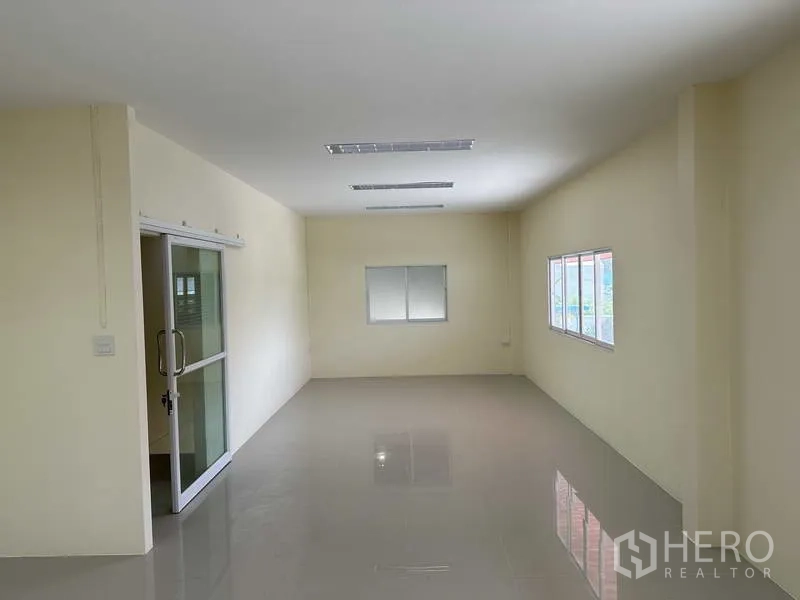 Factory for sale in Mueang Samut Prakan, Samut Prakan - Second-floor office room with windows and sliding glass door, ready for fit-out.