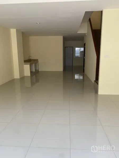 Home Office for rent in Yan Nawa, Bangkok - Open-plan ground floor with glossy white tiles, pantry sink and a staircase in a home office.