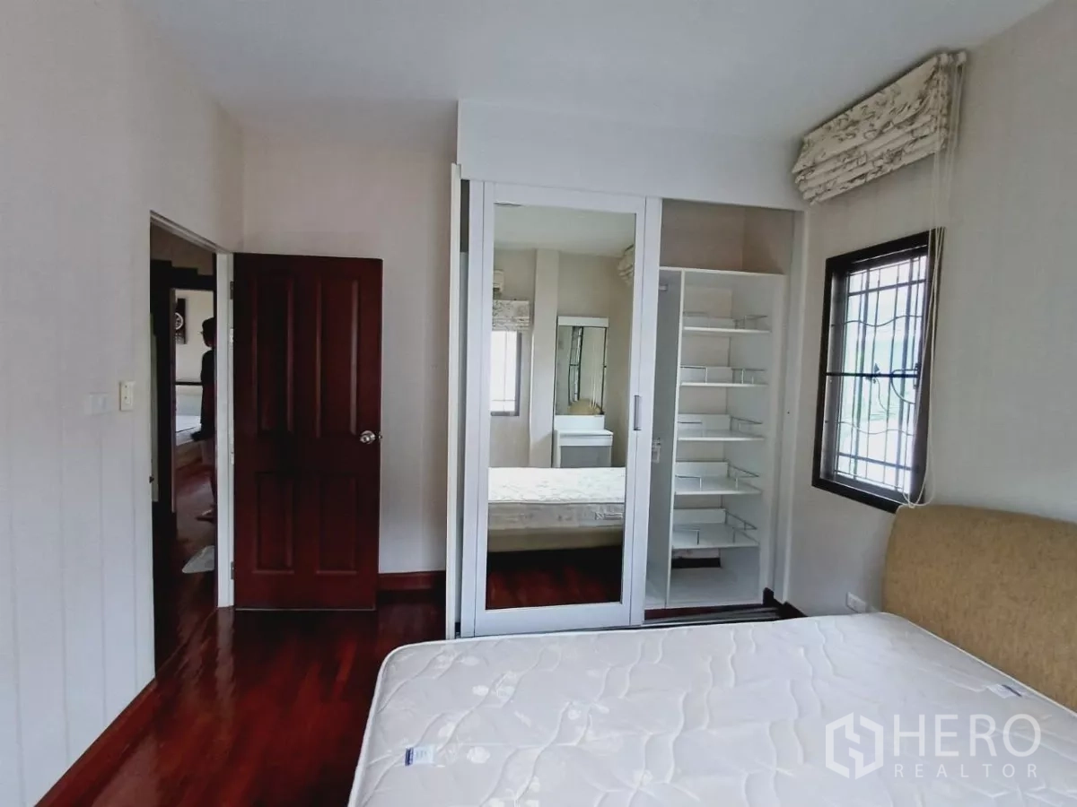 Detached House for rent or sale in Mueang Nonthaburi, Nonthaburi - Bedroom with mirrored sliding-door wardrobe and ample shelving.