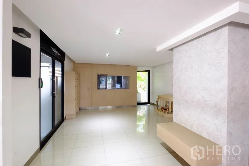 Office Space for rent in Chatuchak, Bangkok - Modern building lobby with polished flooring, mailboxes, reception window and access-controlled glass door.