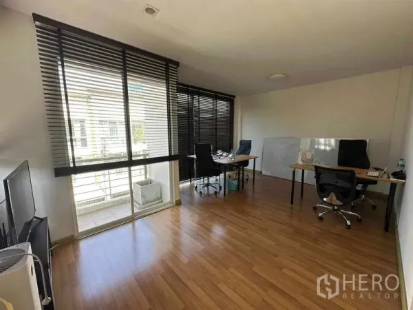 Home Office for rent in Chatuchak, Bangkok - Bright workspace with floor-to-ceiling windows, blinds, balcony access, and desks.