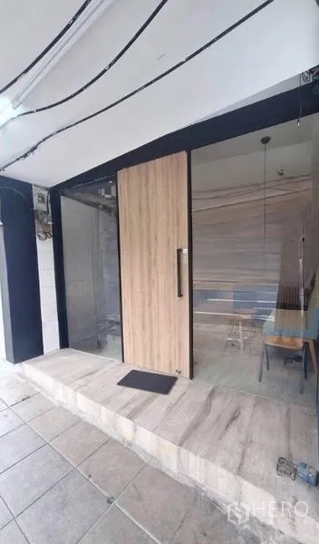 Retail Space for rent in Watthana, Bangkok - Glass-front shop entrance with a wood door and tiled forecourt suitable for signage.