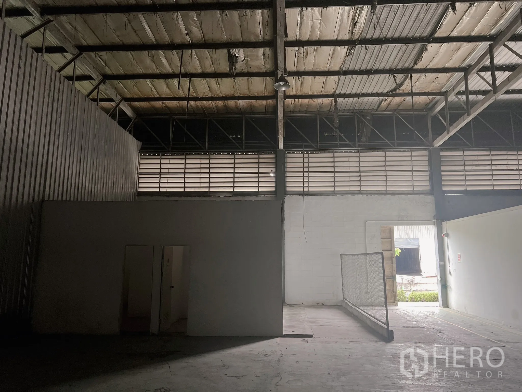 Factory for rent in Bang Pakong, Chachoengsao - Warehouse entry area with ventilation louvres, small rooms and a doorway to the yard.