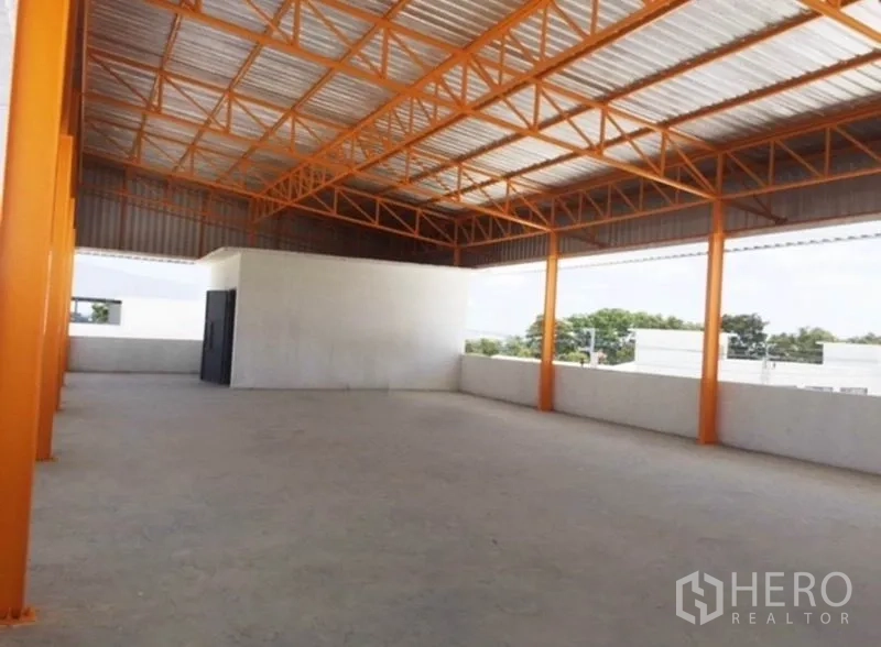 Warehouse for rent in Bang Phli, Samut Prakan - Covered upper-level storage platform with orange steel beams and open sides.