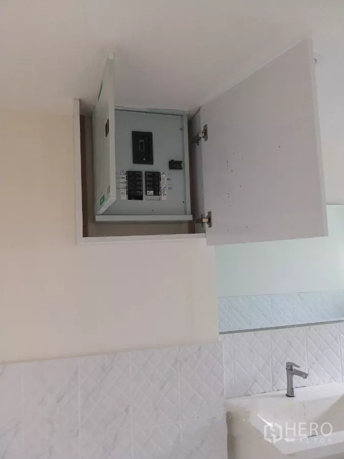 Retail Space for rent - Electrical breaker panel housed in a wall cabinet above the vanity.