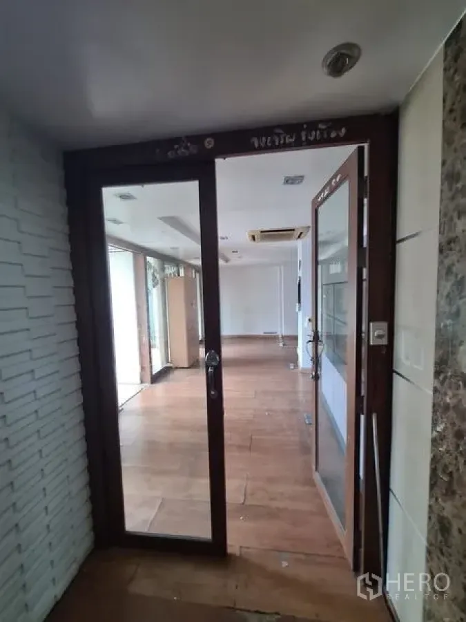 Office Space for rent in Bang Rak, Bangkok - Glass door entry to Bang Rak office with wood flooring and ceiling AC.