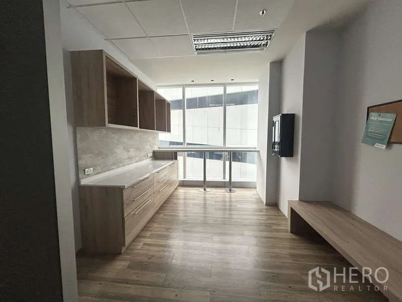 Office Space for rent - Office pantry with wood cabinetry and window bar counter