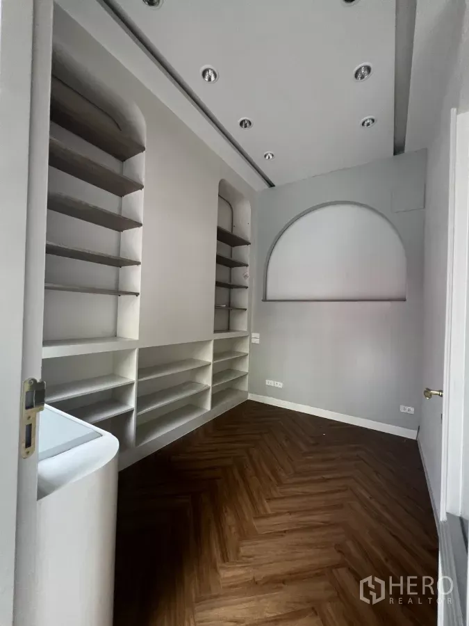 Retail Space for rent in Watthana, Bangkok - Compact retail interior with built-in display shelves, recessed spotlights, and herringbone wood flooring.
