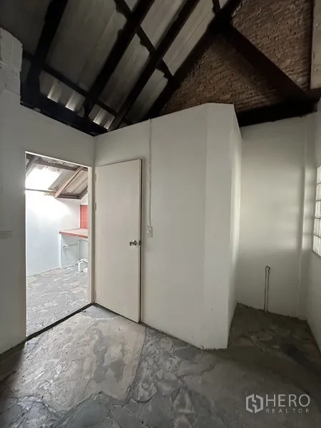 Retail Space for rent in Watthana, Bangkok - Service zone under pitched roof with doorway to utility balcony.