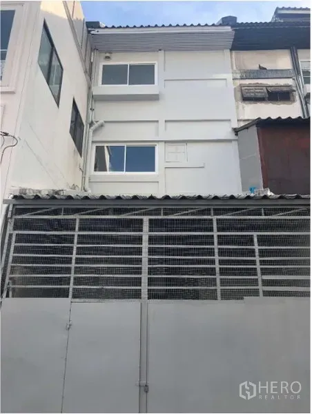 Shophouse for rent in Watthana, Bangkok - Multi-storey shophouse exterior with gated frontage and windows.