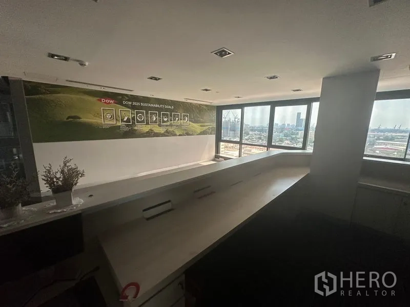 Office Space for rent in Khlong Toei, Bangkok - Reception counter with long built-in desk and city views through large windows.