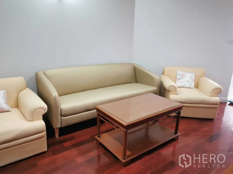 Condominium for rent - Sofa set with two armchairs and a coffee table on hardwood floors.
