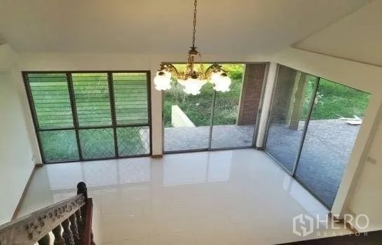 Home Office for rent in Chatuchak, Bangkok - Dining area with floor-to-ceiling windows and views of the green lawn.