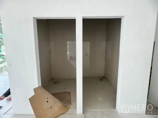 Retail Space for rent in Khlong Toei, Bangkok - Front view of unfinished twin restroom bays with glossy tiles.