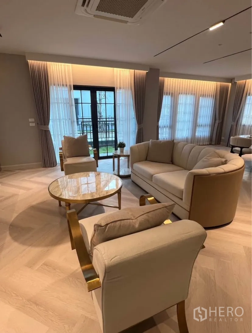Detached House for rent in Bang Phli, Samut Prakan - Bright lounge seating facing sliding doors with sheer curtains and warm cove lighting.
