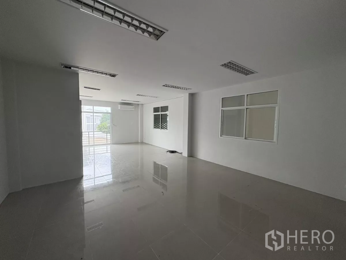Factory for rent in Phra Samut Chedi, Samut Prakan - Bright mezzanine office with polished tiles, windows and balcony access.