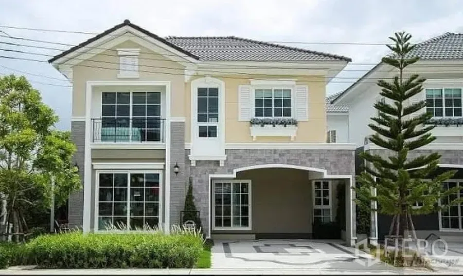 Detached House for rent or sale in Prawet, Bangkok - Two-storey detached house exterior with covered carport, large windows and landscaped yard.