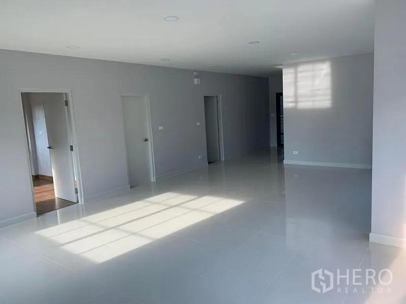 Detached House for rent or sale in Bang Phli, Samut Prakan - Spacious living and dining room with recessed lighting and multiple interior doors