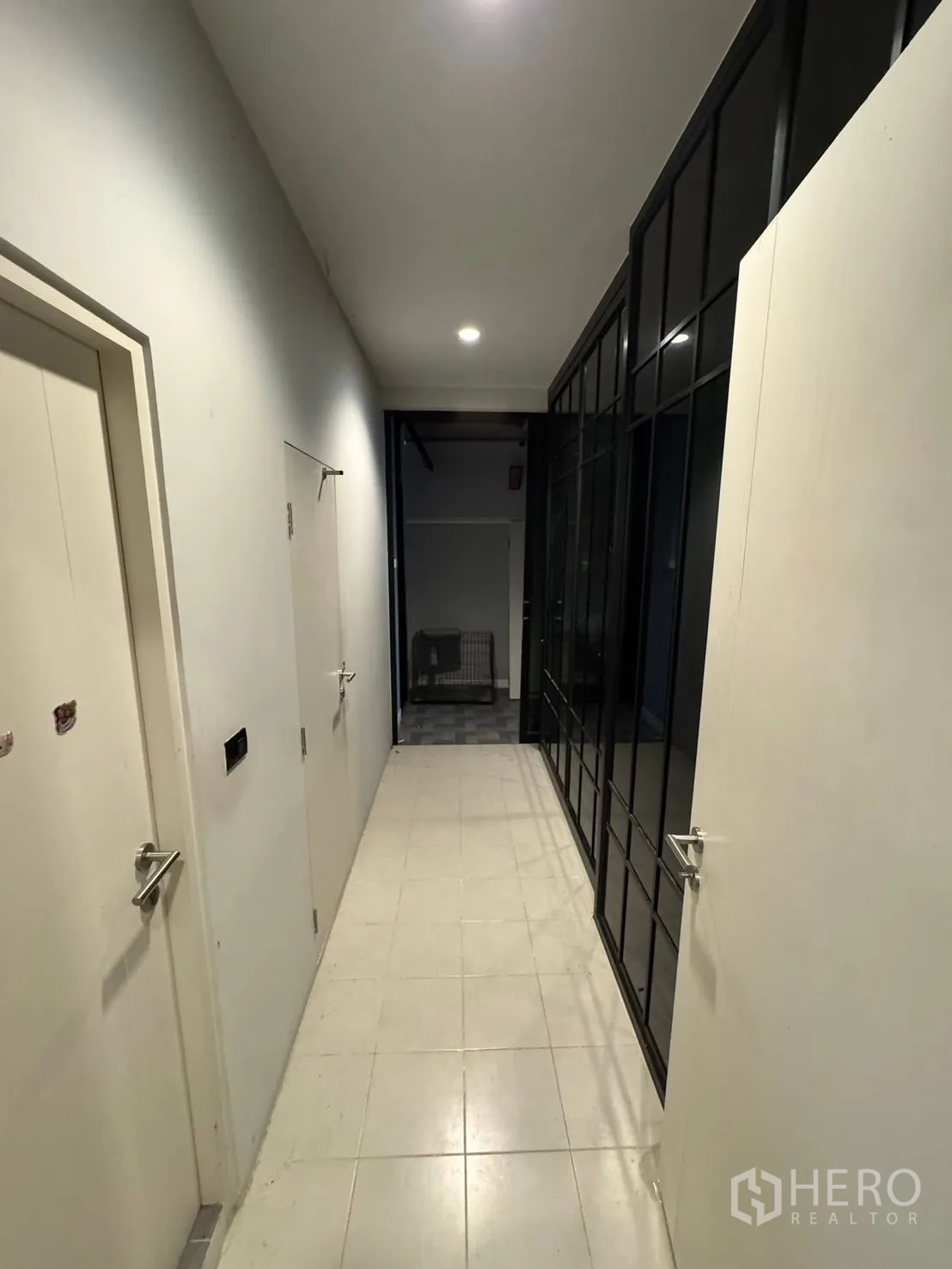 Detached House for sale in Mueang Pathum Thani, Pathum Thani - Service corridor with storage rooms and black framed glass partitions.