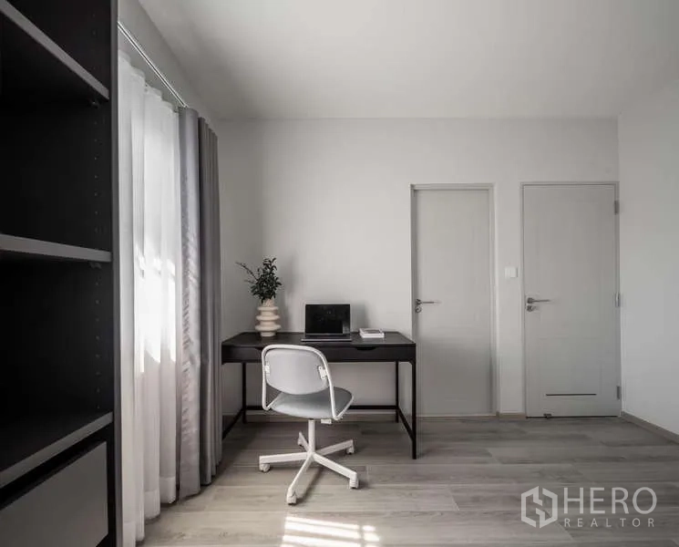 Detached House for rent or sale in Bang Phli, Samut Prakan - Minimalist work space with black desk, chair and two interior doors.
