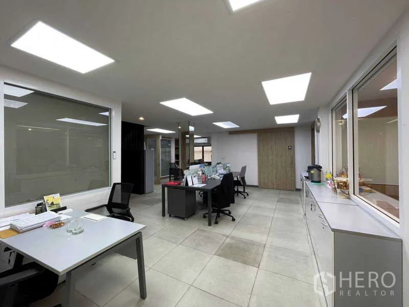 Home Office for rent in Watthana, Bangkok - Spacious open-plan office with multiple desks and ceiling light panels.