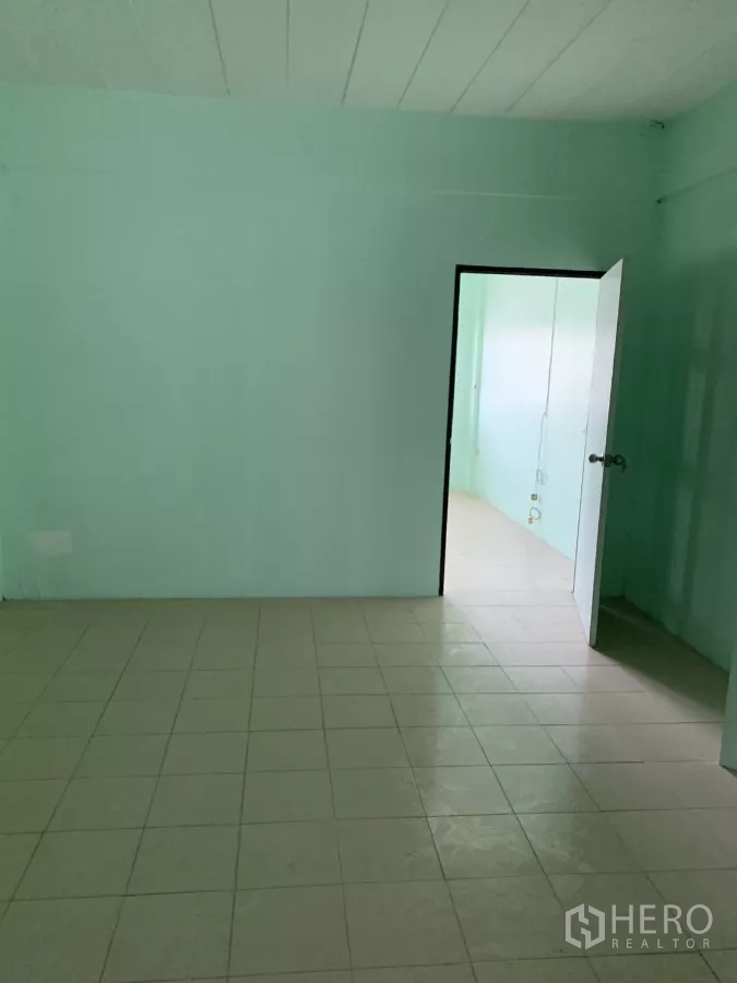 Shophouse for rent in Suan Luang, Bangkok - Empty tiled room with an open doorway and light green walls.