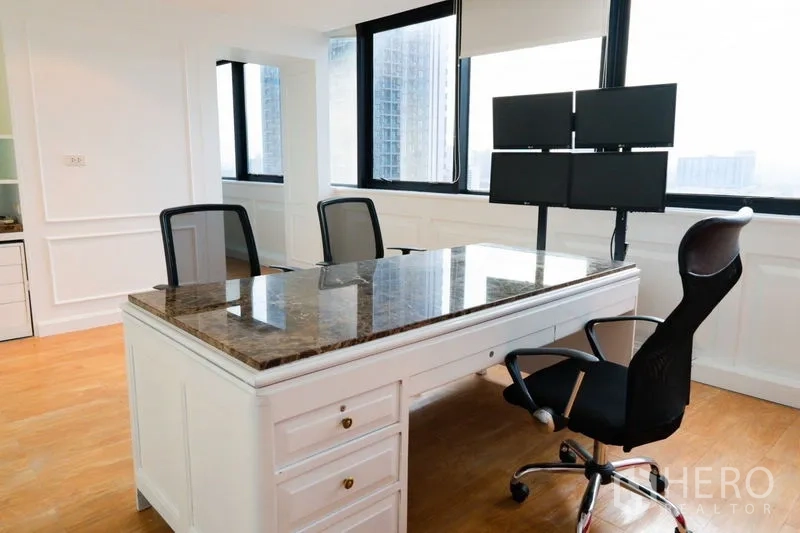 Office Space for rent - Corner executive workstation with marble-top desk and multiple monitors.
