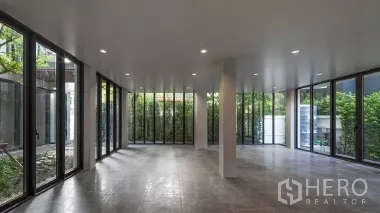 Home Office for rent or sale in Phra Khanong, Bangkok - Open-plan ground floor with floor-to-ceiling glass and garden views.