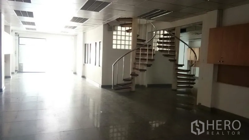 Office Space for rent in Sathon, Bangkok - Open office area featuring a curved spiral staircase and grid ceiling lights.