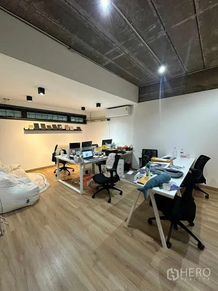 Home Office for rent in Wang Thonglang, Bangkok - Furnished office room with desks and task chairs under an exposed ceiling