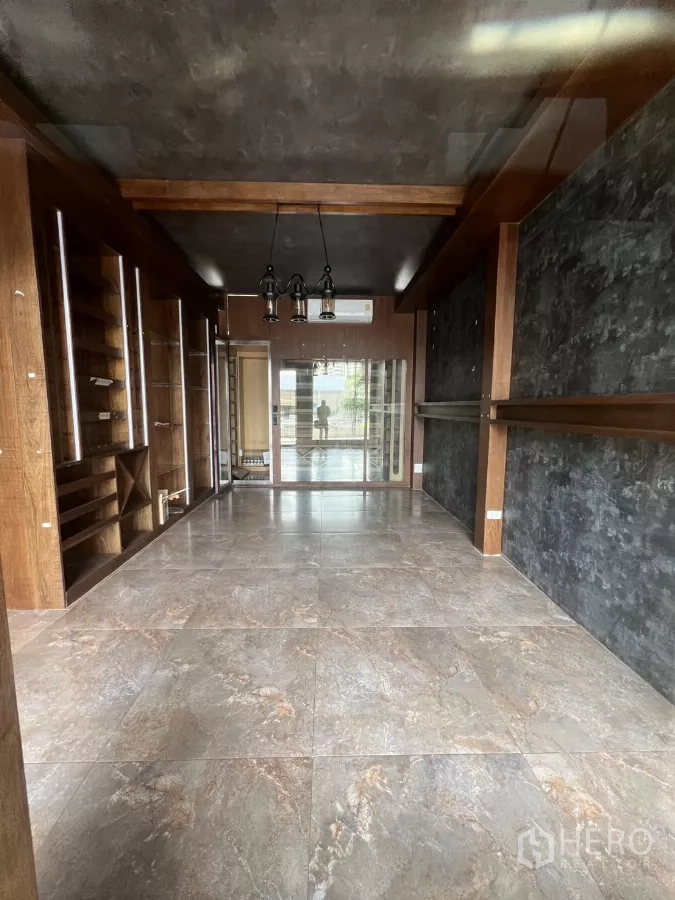 Retail Space for rent - Boutique-style interior with display shelves and glass partition to the front terrace.