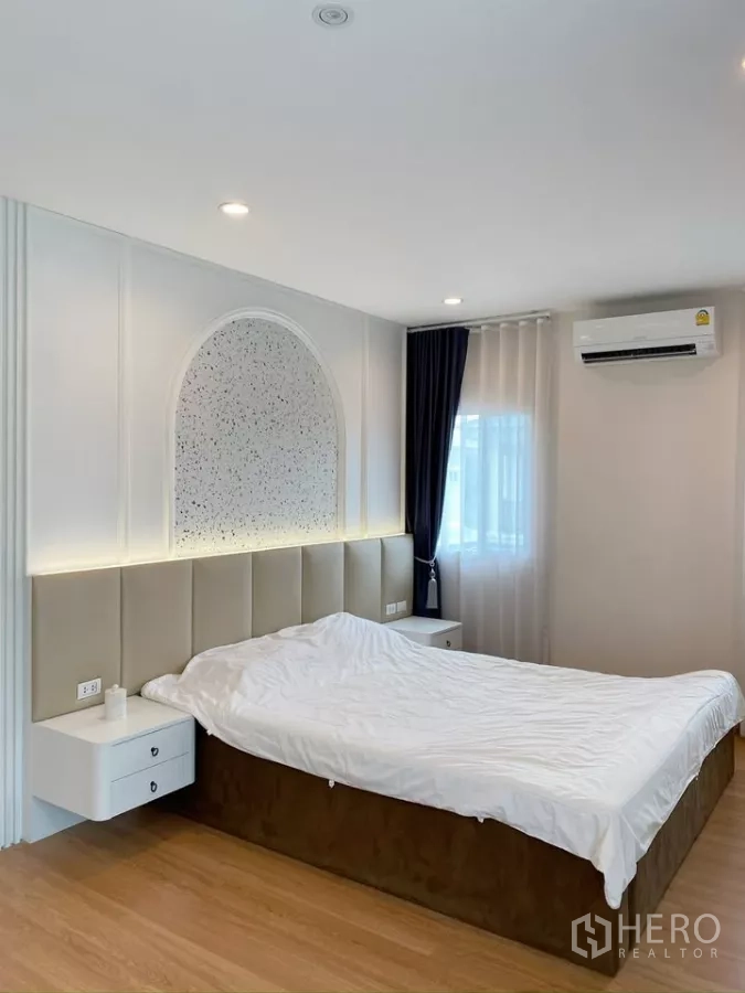 Detached House for sale in Sai Mai, Bangkok - Master bedroom headboard wall with arched backlit panel and side tables.