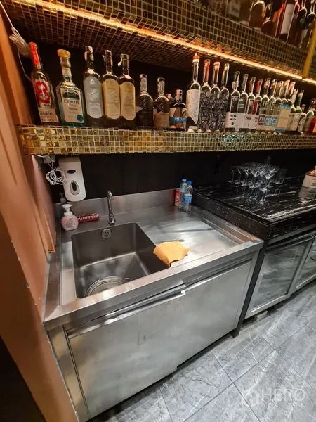 Retail Space for rent in Bang Rak, Bangkok - Back bar with black marble counter, bottle display and high gold grid ceiling.