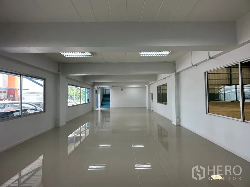 Factory for rent in Bang Phli, Samut Prakan - Open‑plan office area with fluorescent lighting and stair access.